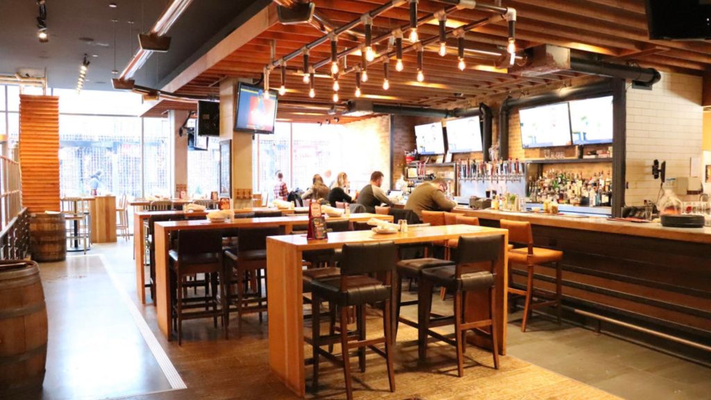 a brewery bar with people sitting at it